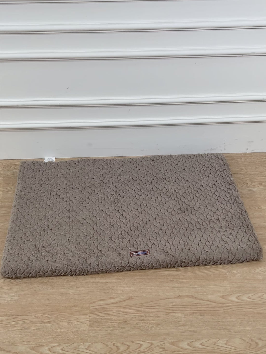 Brown textured rug on a wooden floor
